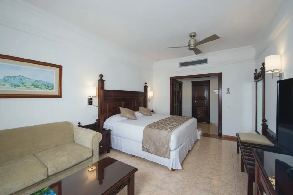 Ocean View room with king bed and sofa at Hotel Riu Palace Cabo San Lucas.