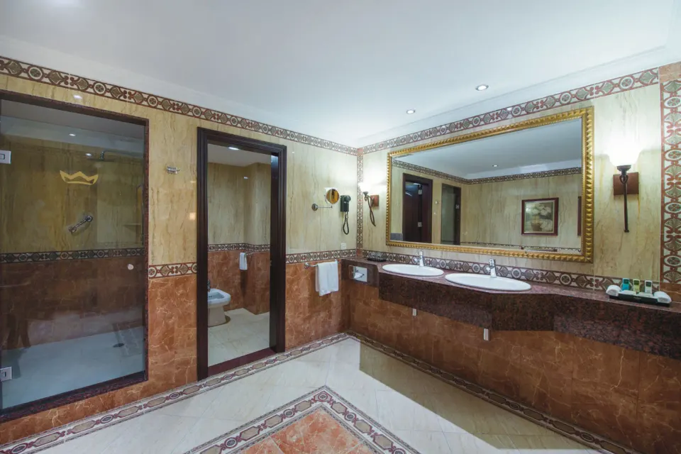 Suite bathroom with double sinks and glass shower at Hotel Riu Palace Cabo San Lucas.