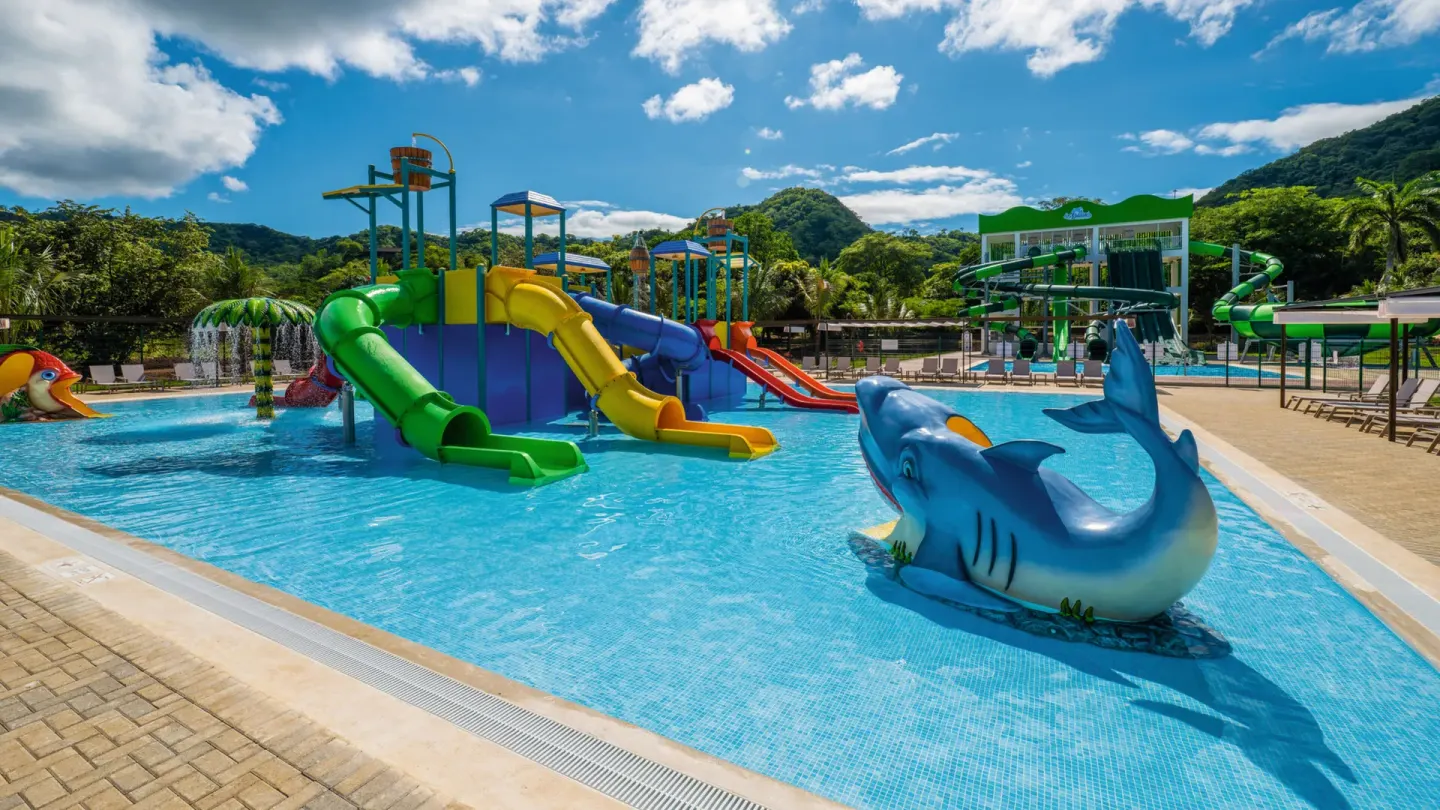 Children's splash pool with colorful slides at Hotel Riu Palace Costa Rica.