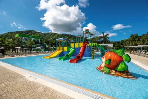 Kids' water play area with slides and a fish feature at Hotel Riu Palace Costa Rica.
