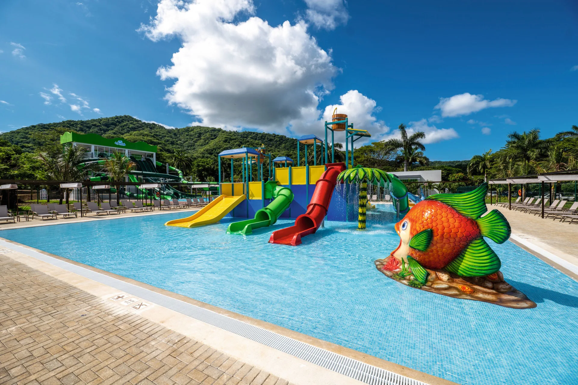 Kids' water play area with slides and a fish feature at Hotel Riu Palace Costa Rica.