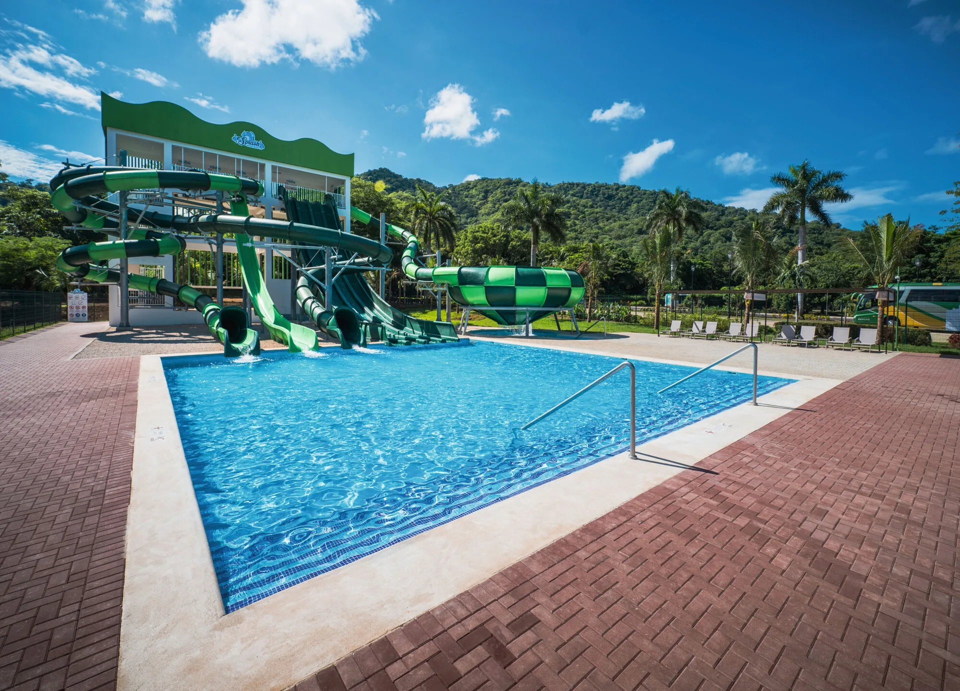 Waterslide pool with wide deck and handrails at Hotel Riu Palace Costa Rica.
