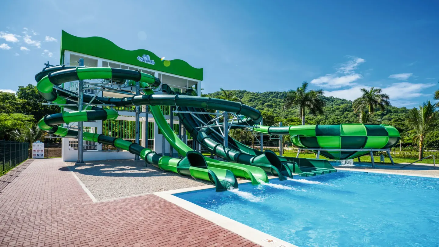 Green waterslides and splash pool at Hotel Riu Palace Costa Rica.