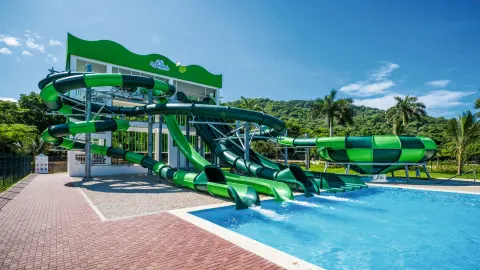 Green waterslides and splash pool at Hotel Riu Palace Costa Rica.