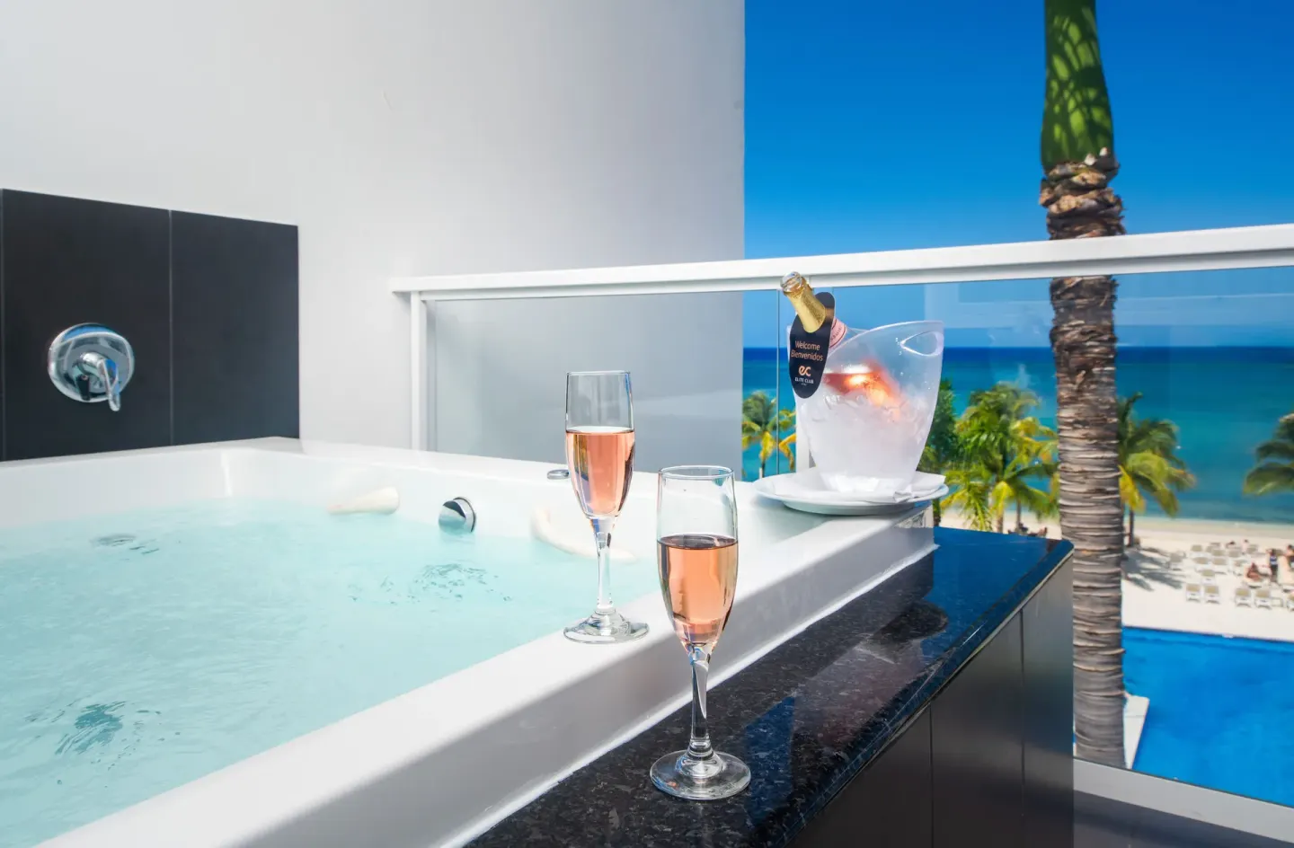 Balcony whirlpool with sparkling wine and beach view at Hotel Riu Palace Jamaica.
