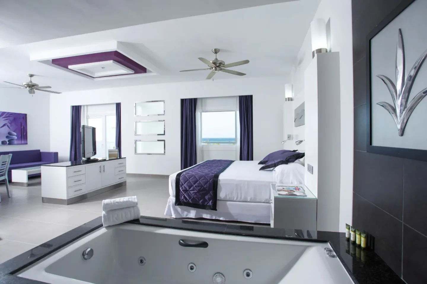 Guest suite with king bed and in-room whirlpool at Hotel Riu Palace Jamaica.