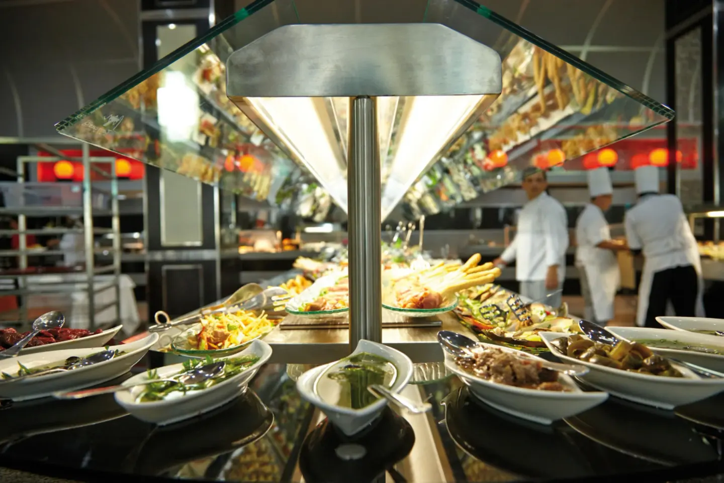 Buffet station with prepared dishes and chefs at Hotel Riu Palace Jamaica.