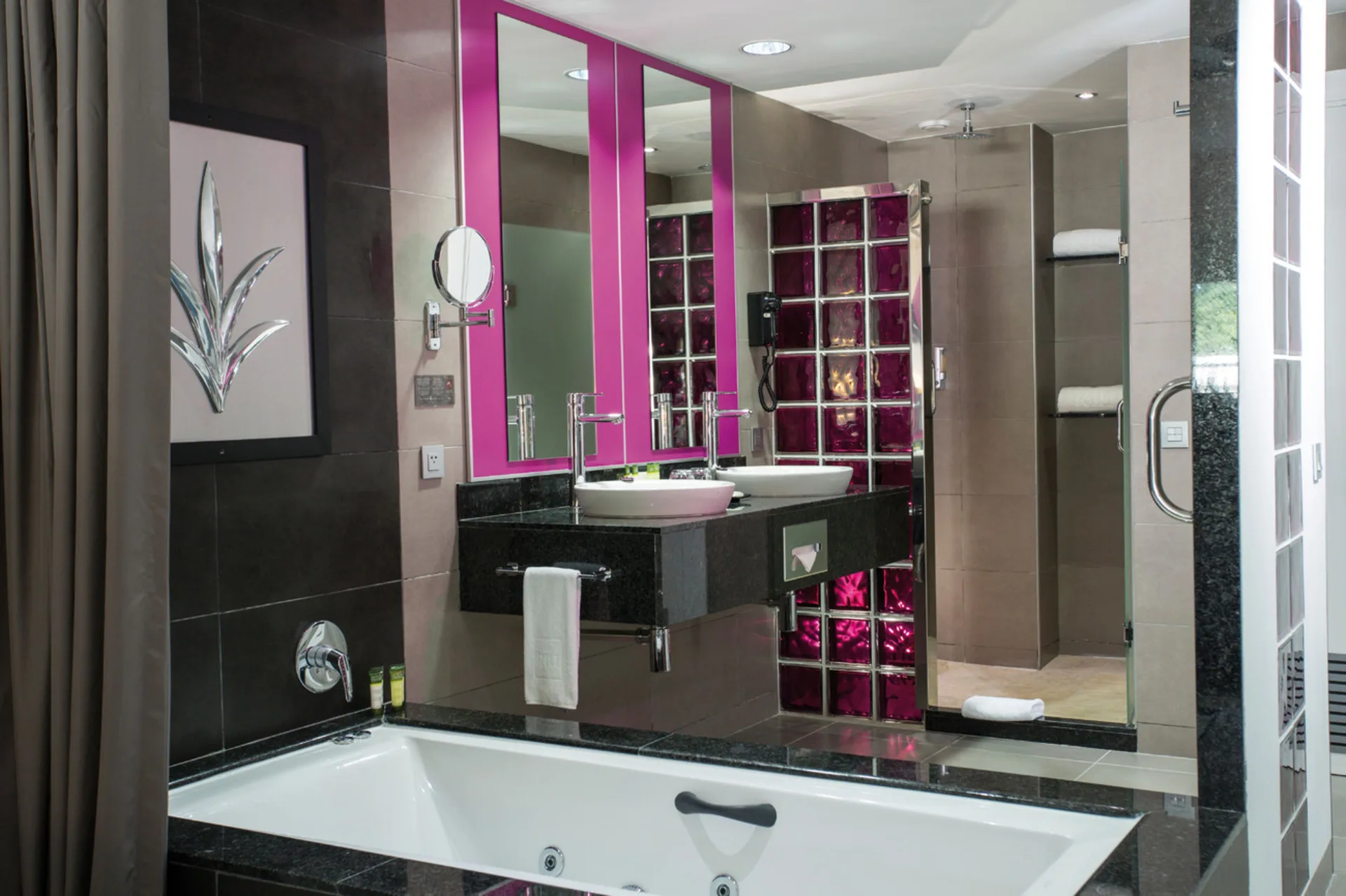 Junior Suite Garden View bathroom with tub, vanity and shower at Hotel Riu Palace Jamaica.
