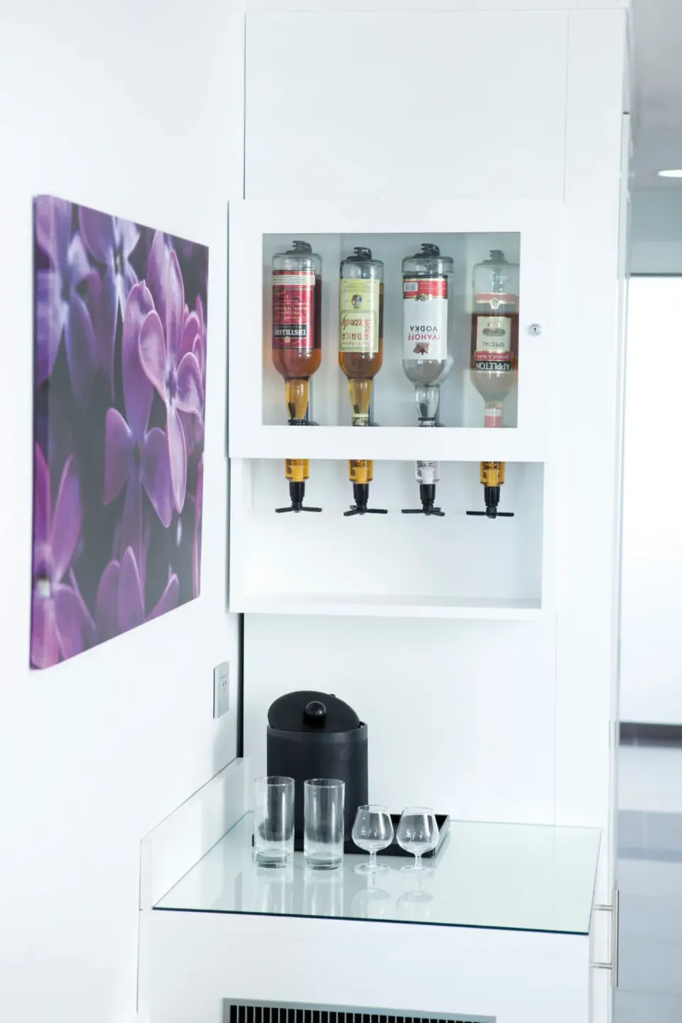 Junior Suite Garden View liquor dispenser and glassware at Hotel Riu Palace Jamaica.