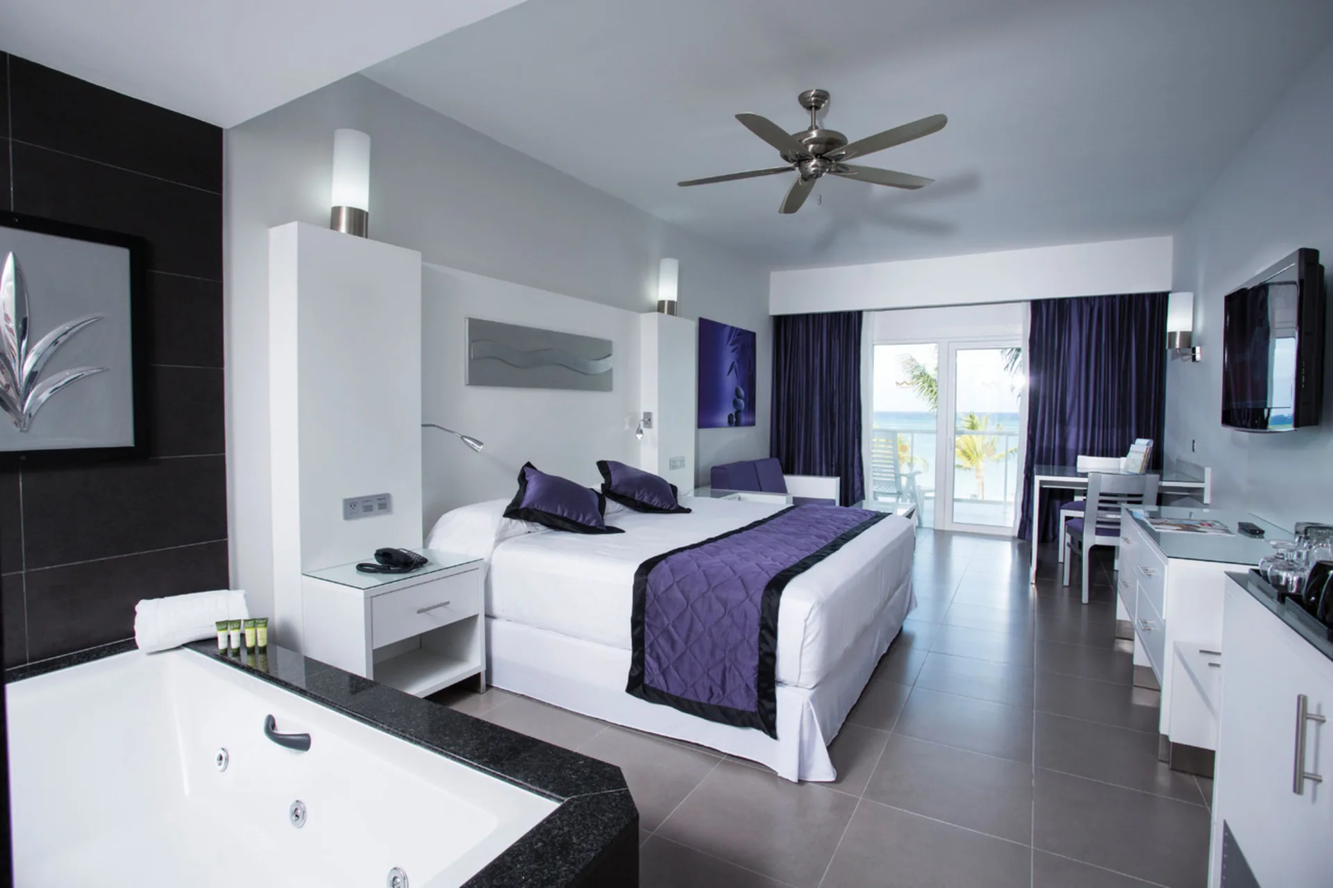 Junior Suite Ocean View room with king bed and in-room whirlpool at Hotel Riu Palace Jamaica.