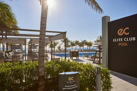 Elite Club pool entrance and oceanfront loungers at Hotel Riu Palace Kukulkan.