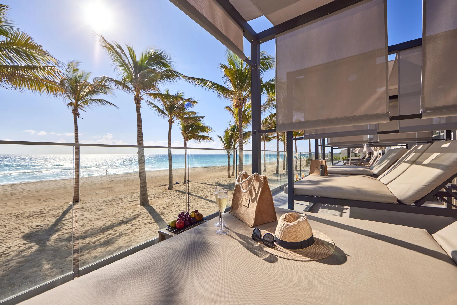 Shaded beach lounger with ocean view at Hotel Riu Palace Kukulkan.