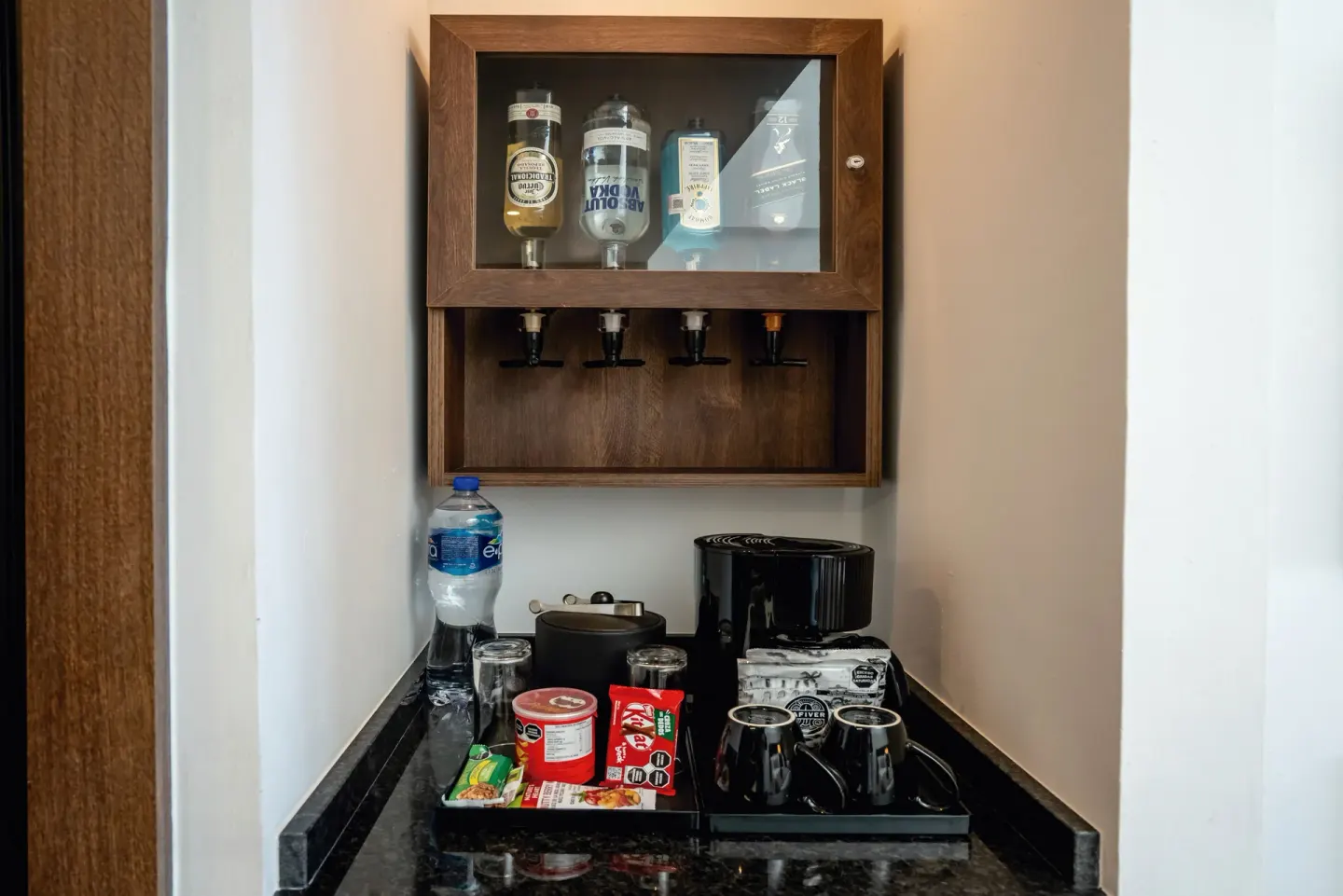 In-room minibar and coffee station in a Junior Suite at Hotel Riu Palace Kukulkan.