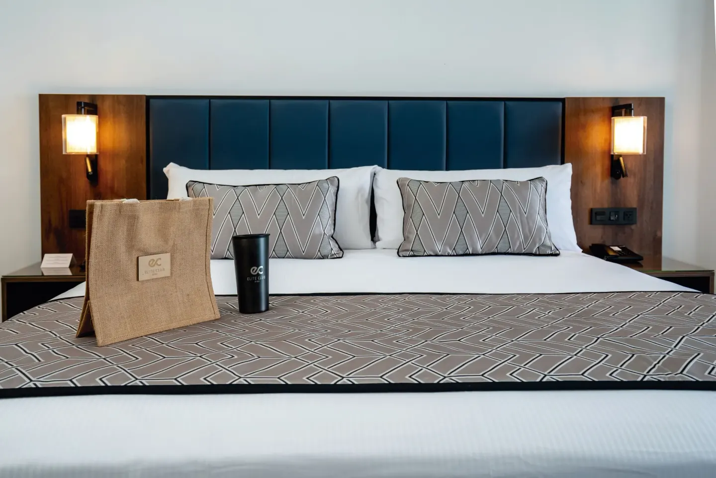 Junior Suite Ocean View Elite Club king bed with welcome items at Hotel Riu Palace Kukulkan.