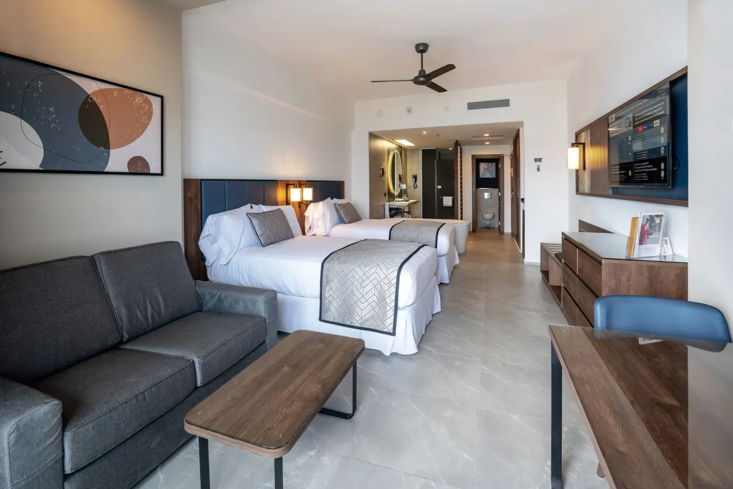 Junior Suite Ocean View with two beds and sofa at Hotel Riu Palace Kukulkan.