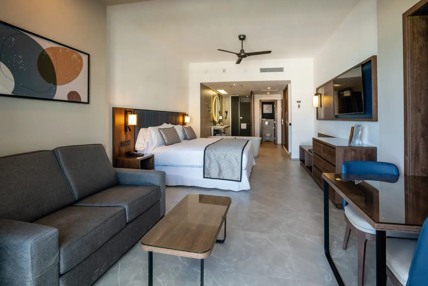 Junior Suite sitting area and king bed at Hotel Riu Palace Kukulkan.