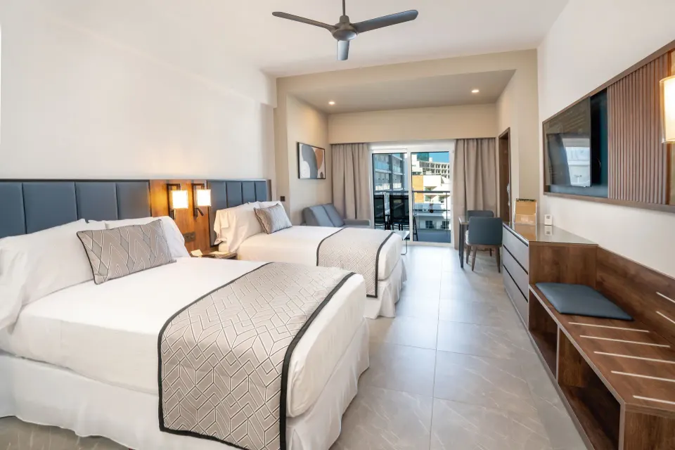 Junior Suite with two beds and balcony at Hotel Riu Palace Kukulkan.