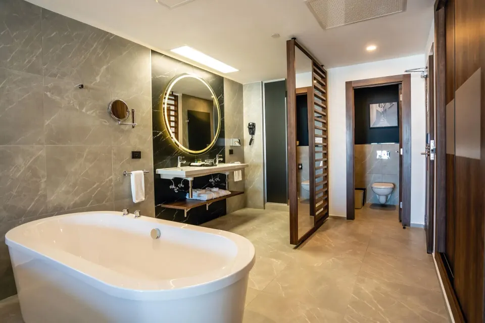 Junior Suite Partial Ocean View bathroom with tub and vanity at Hotel Riu Palace Kukulkan.