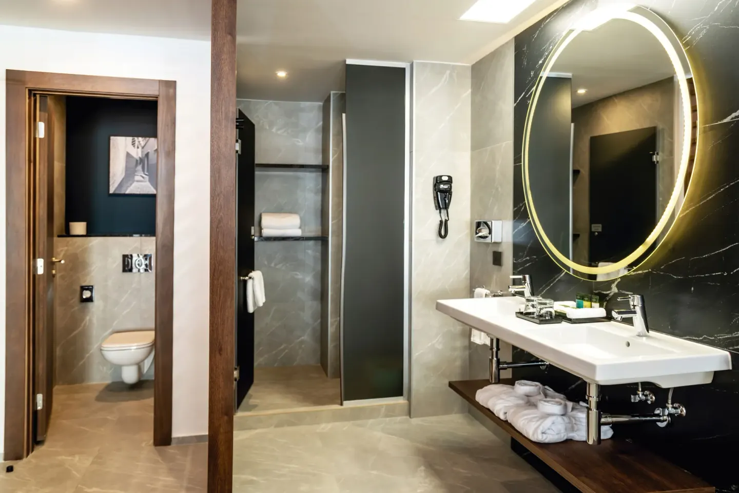 Junior Suite bathroom at Hotel Riu Palace Kukulkan with vanity, shower, and separate toilet area.