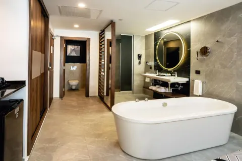 Junior Suite bathroom with freestanding tub and vanity at Hotel Riu Palace Kukulkan.