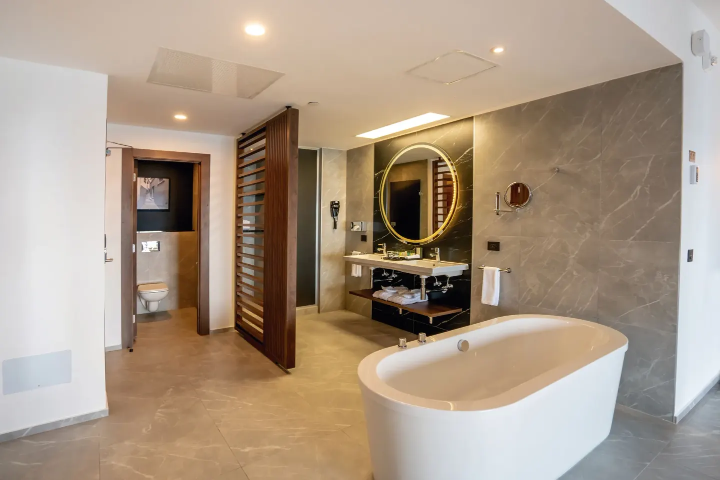 Suite Ocean View Elite Club bathroom at Hotel Riu Palace Kukulkan with freestanding tub and vanity.