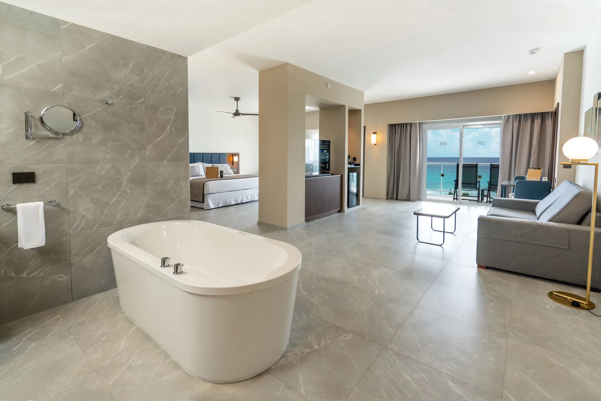 Suite Ocean View Elite Club with freestanding tub and balcony at Hotel Riu Palace Kukulkan.