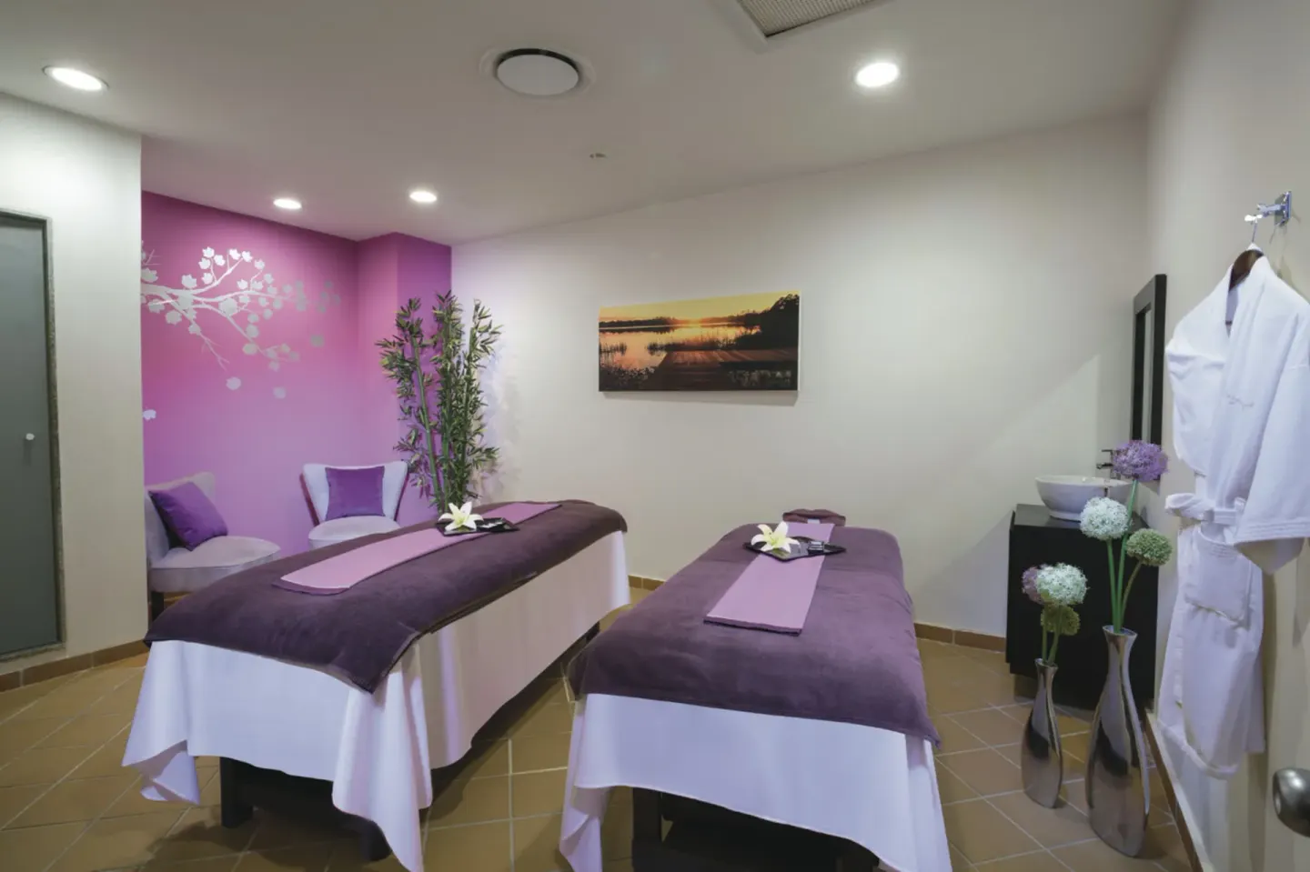Spa treatment room with two massage tables at Hotel Riu Palace Las Americas.