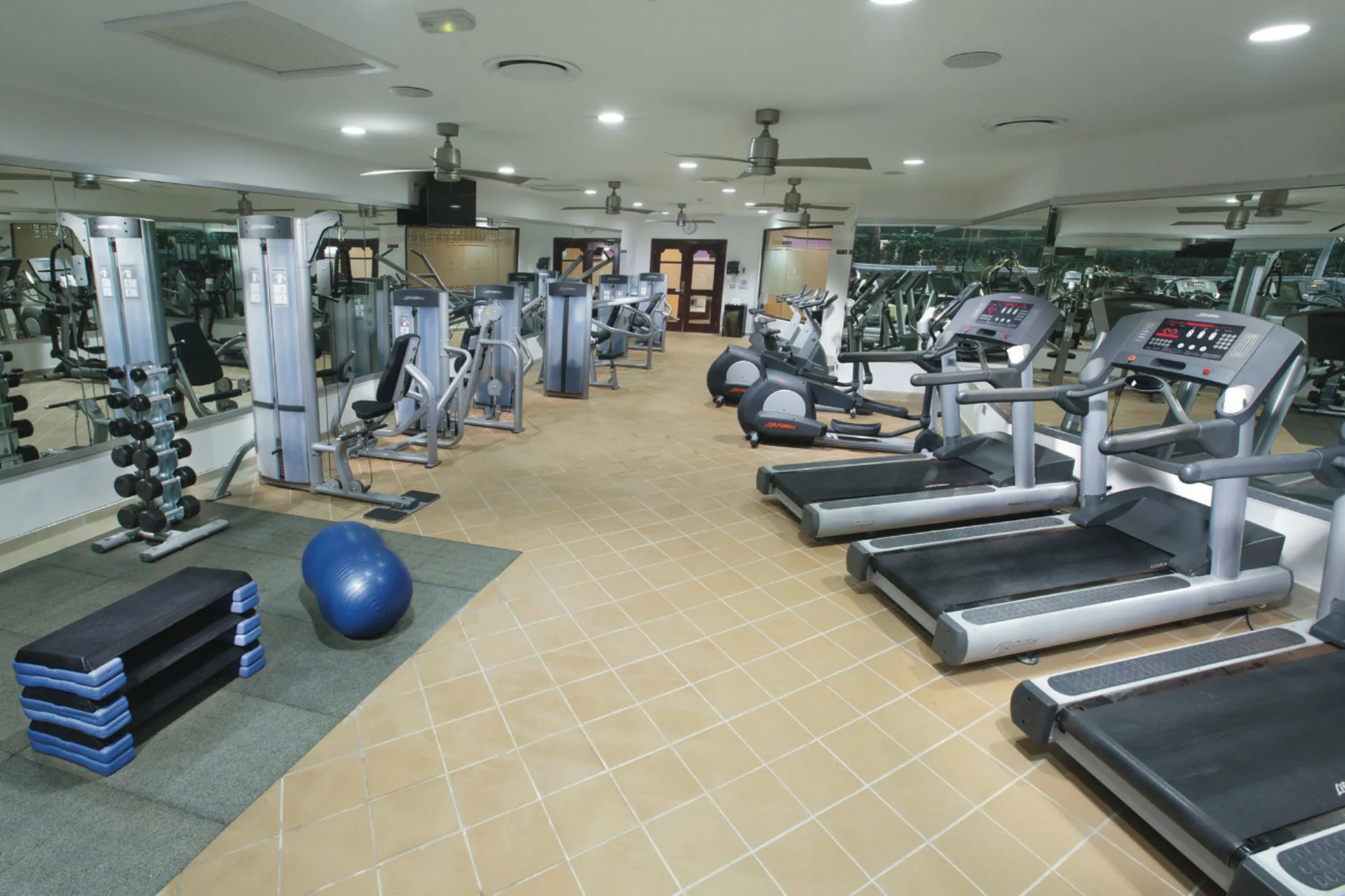 Fitness center with treadmills and weight equipment at Hotel Riu Palace Las Americas.