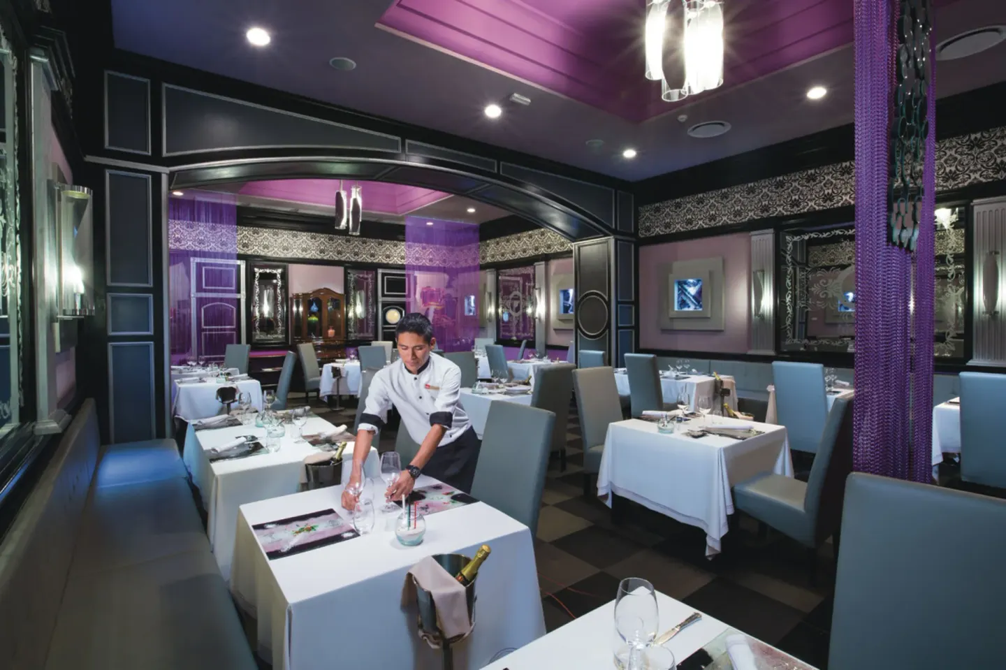 Elegant restaurant dining room with purple accents at Hotel Riu Palace Las Americas.