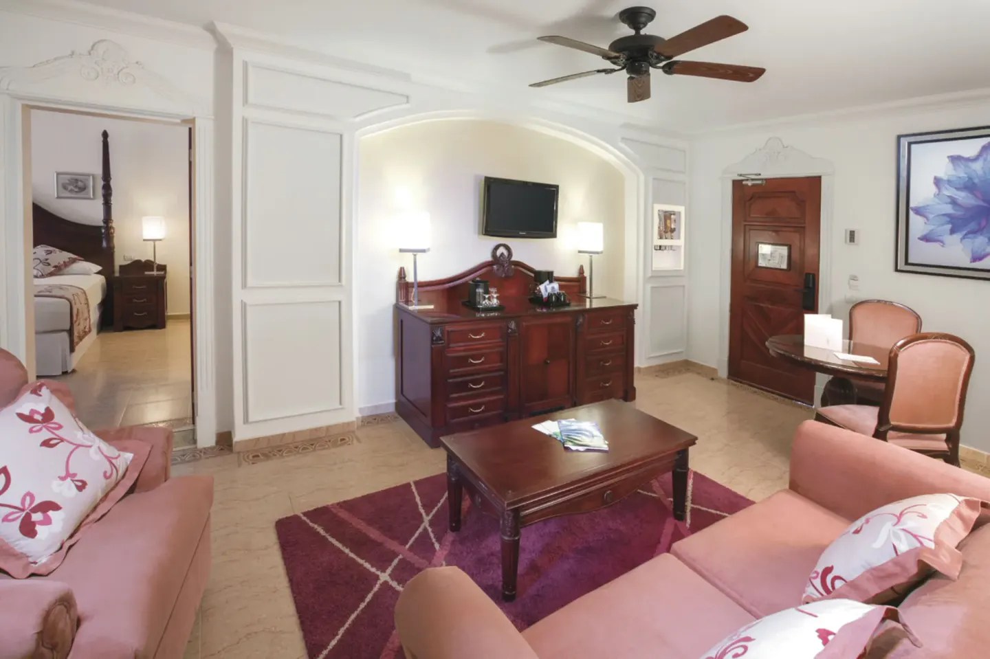 Ocean view suite sitting room with sofas and bedroom doorway at Hotel Riu Palace Las Americas.