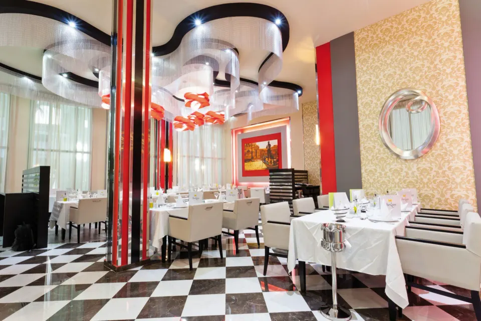 Modern black-and-white checkered restaurant with white tablecloths at Hotel Riu Palace Mexico