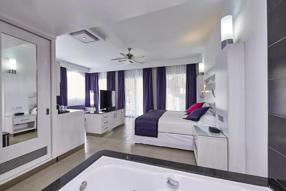 Suite Garden View room with king bed and in-room whirlpool at Hotel Riu Palace Mexico