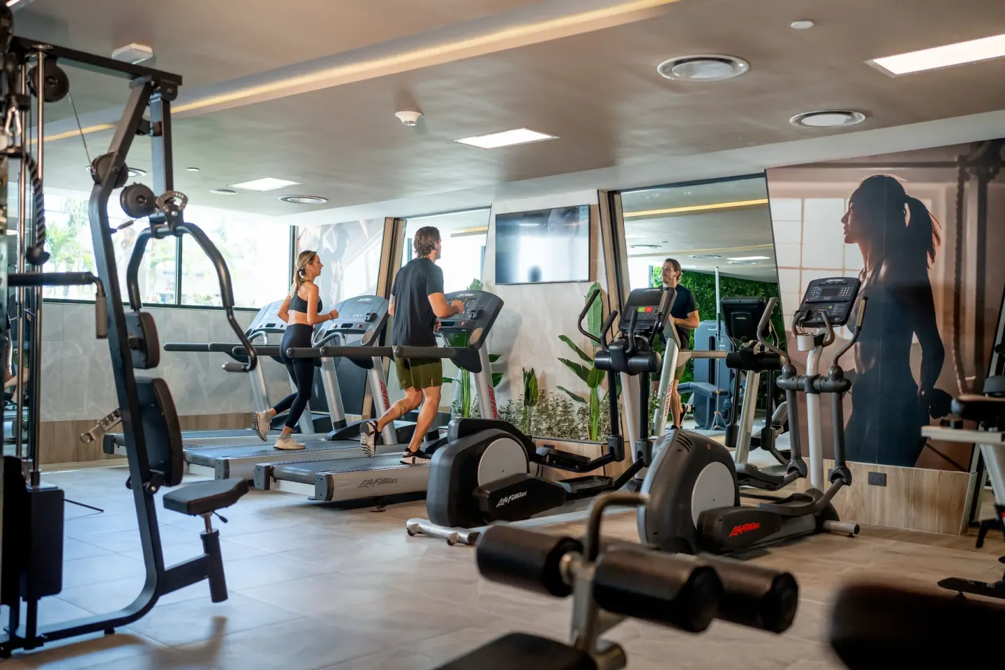 Fitness center with treadmills and exercise machines at Hotel Riu Palace Pacifico.