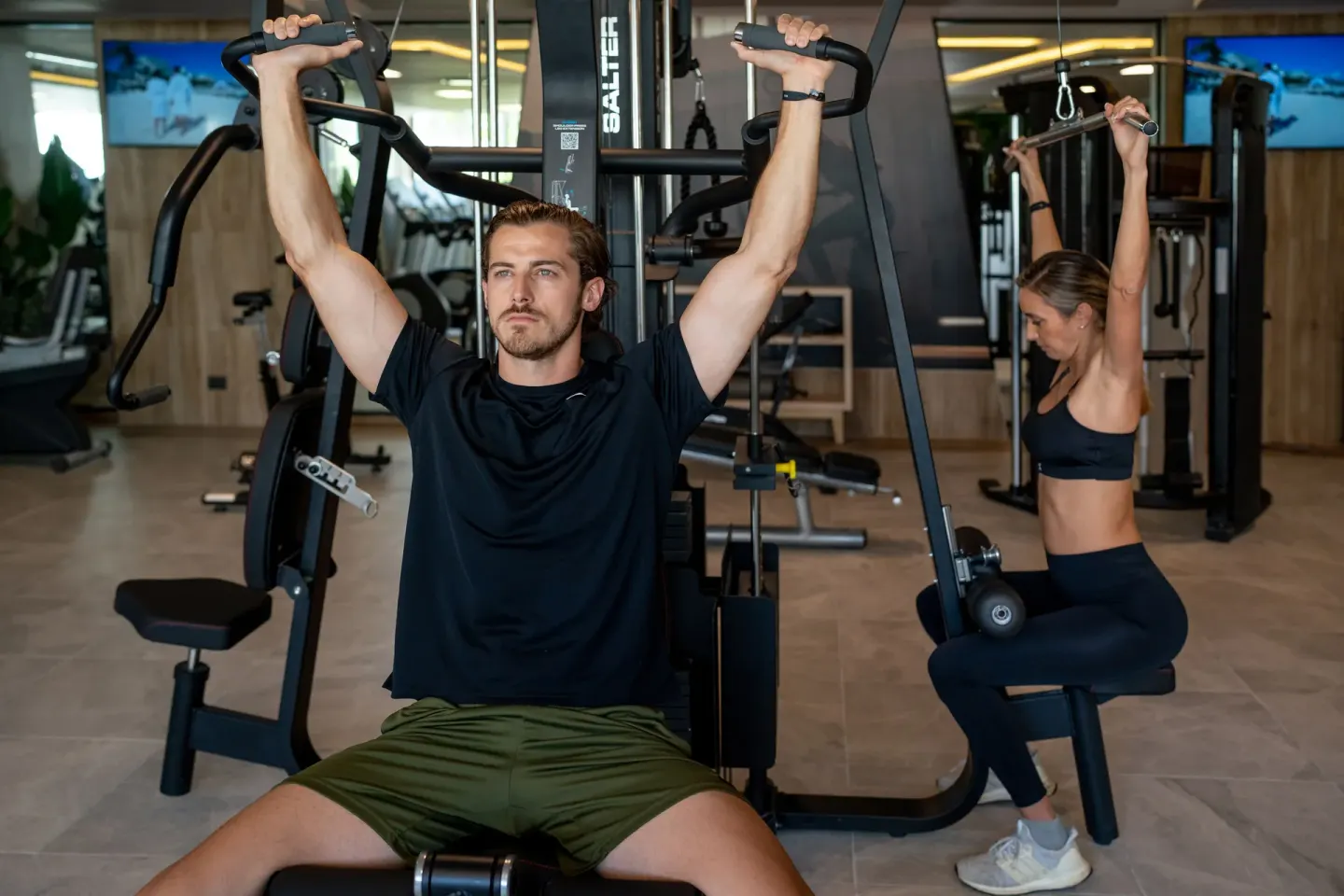 Guests using weight machines in the gym at Hotel Riu Palace Pacifico.