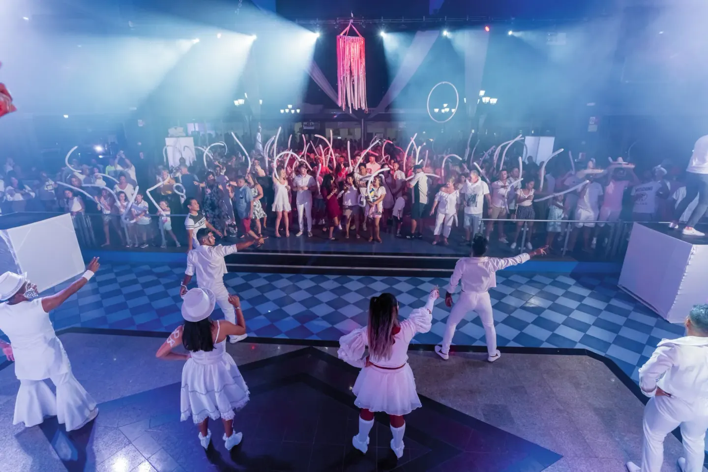 A crowd joins performers during a nightclub-style show at Hotel Riu Palace Pacifico.
