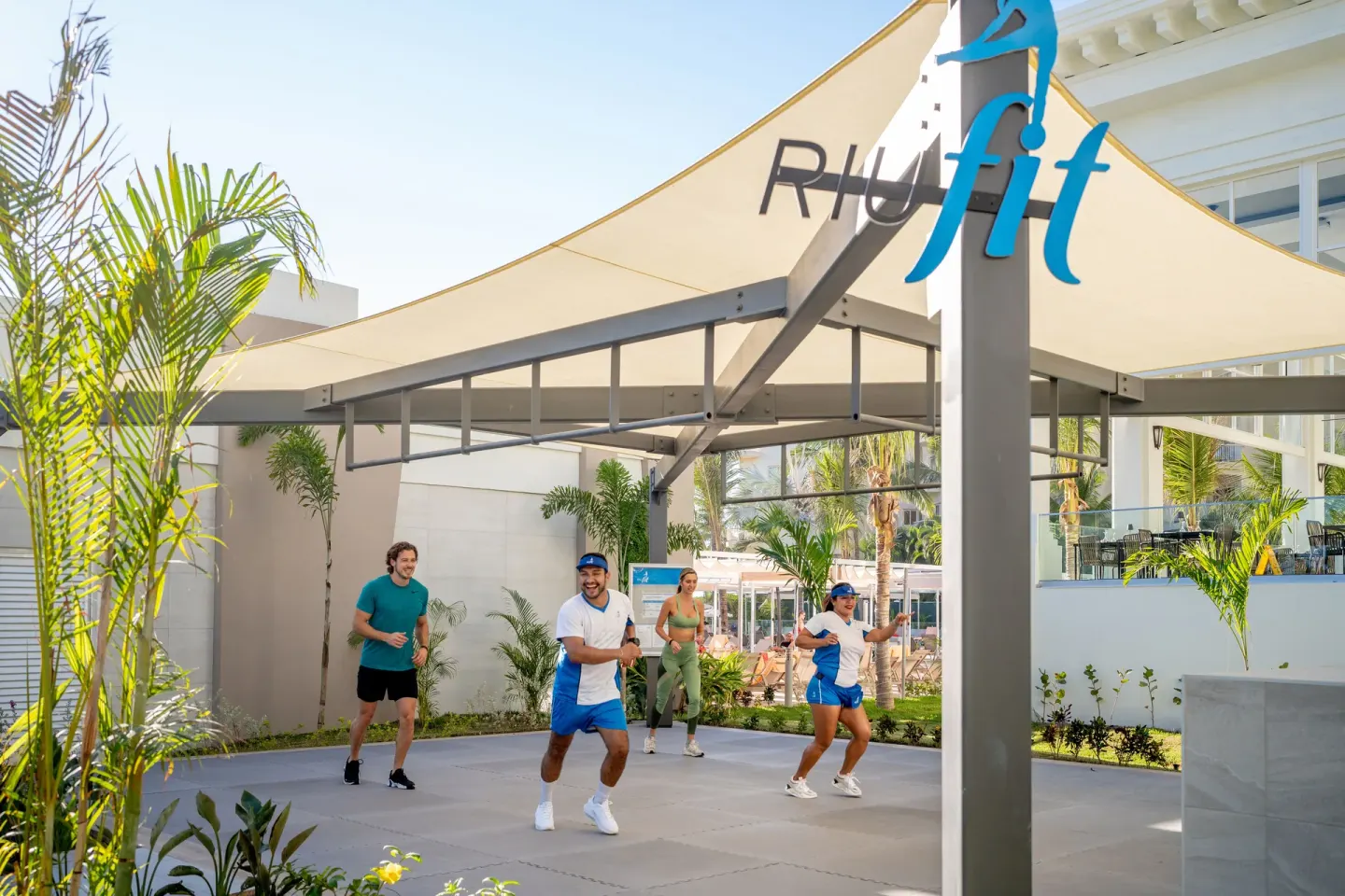 Outdoor fitness class under the RiuFit canopy at Hotel Riu Palace Pacifico.