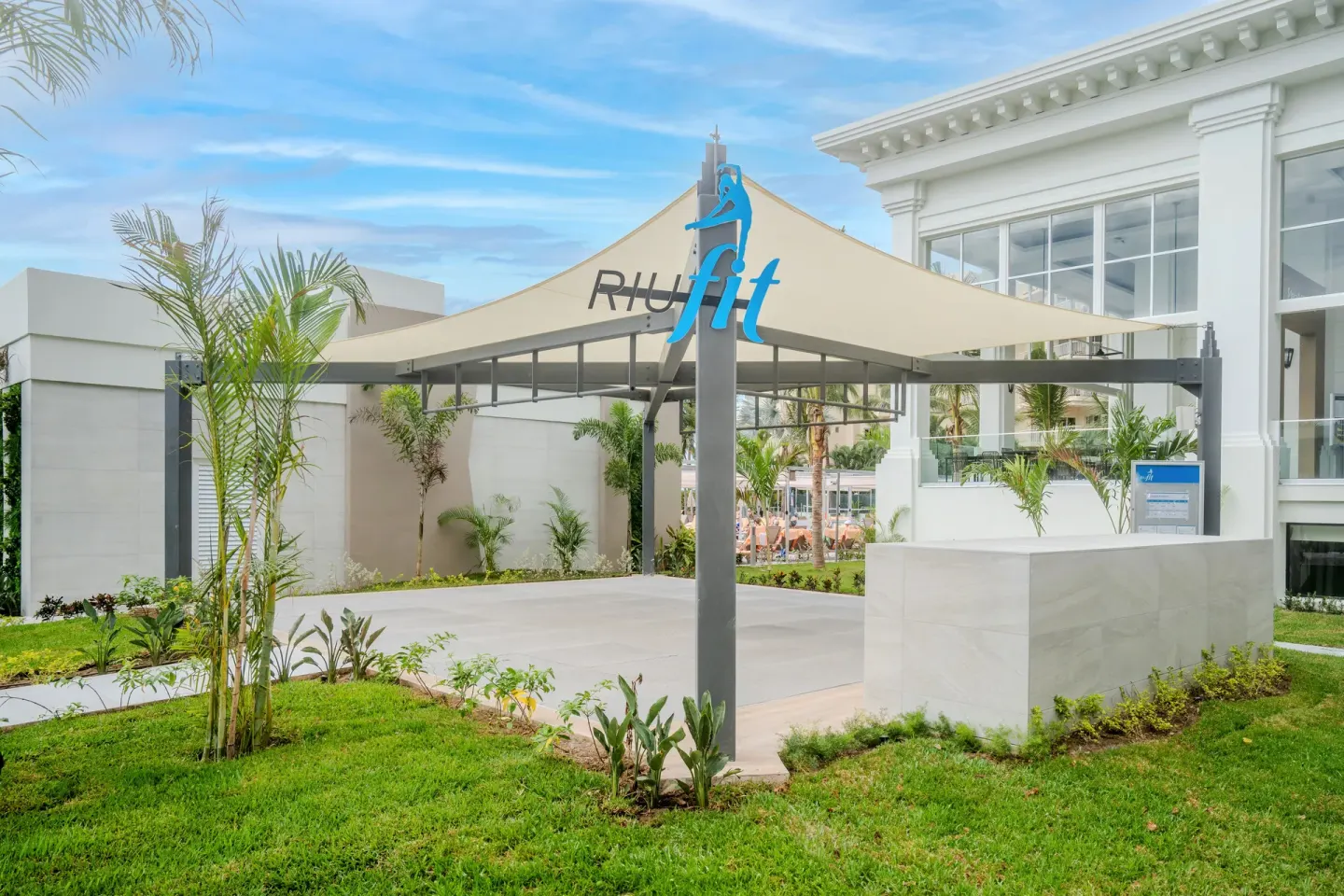 Outdoor RiuFit activity canopy on landscaped grounds at Hotel Riu Palace Pacifico.