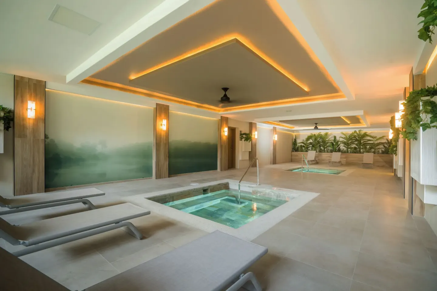 Spa hydrotherapy room with plunge pools and loungers at Hotel Riu Palace Pacifico.