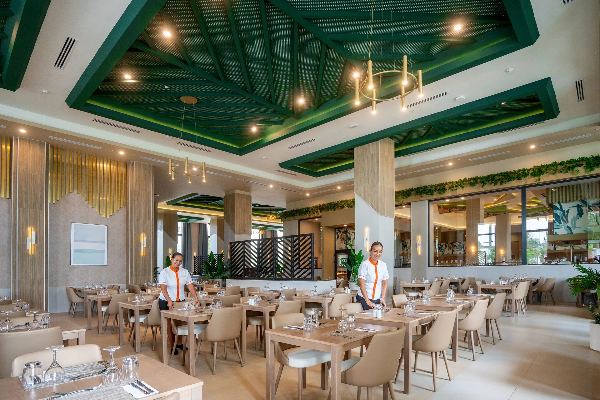 Bright dining room with set tables and green ceiling details at Hotel Riu Palace Pacifico.
