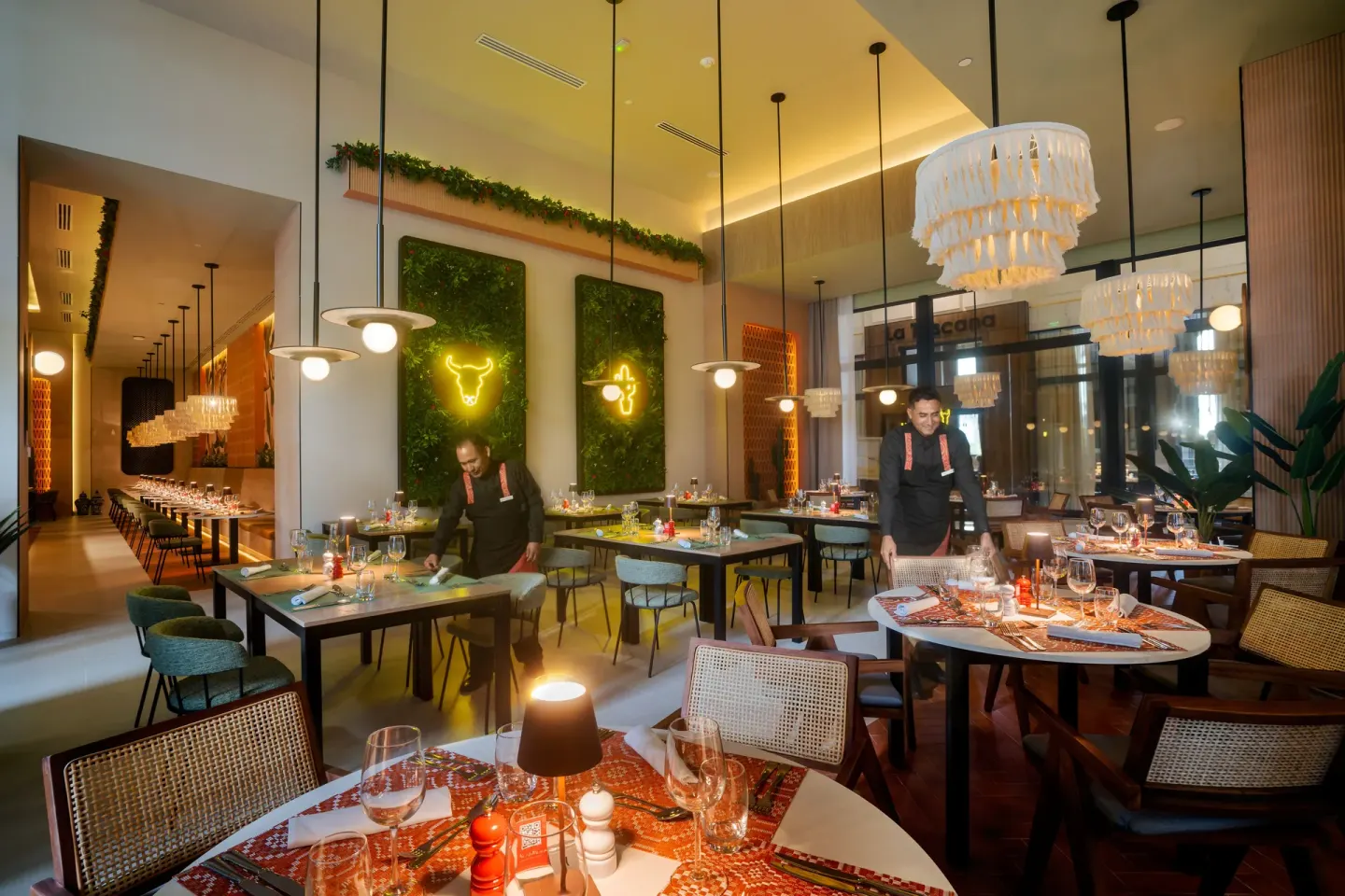 Guacamole restaurant dining room with bull wall lights at Hotel Riu Palace Pacifico.