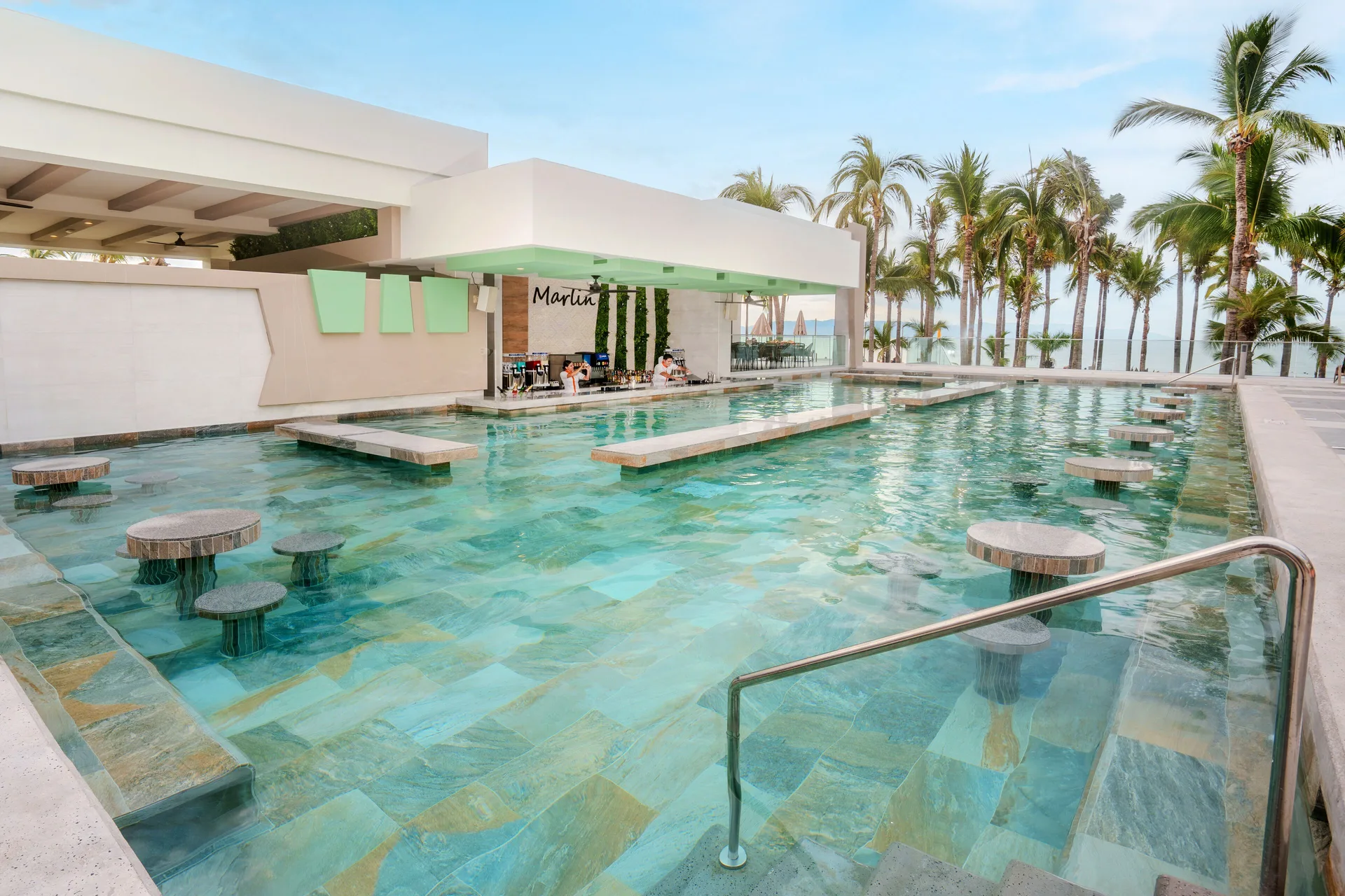 Swim-up pool bar with in-water stools at Hotel Riu Palace Pacifico.