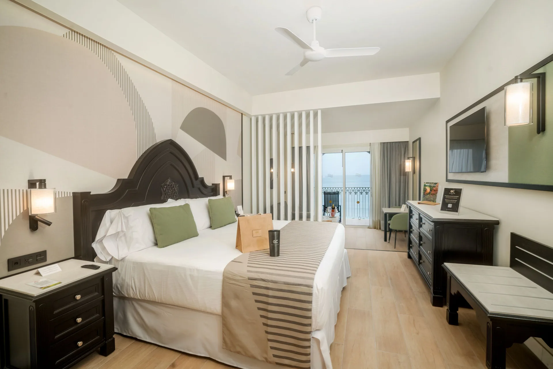 Elite Club Junior Suite Oceanfront king bed and balcony at Hotel Riu Palace Pacifico.