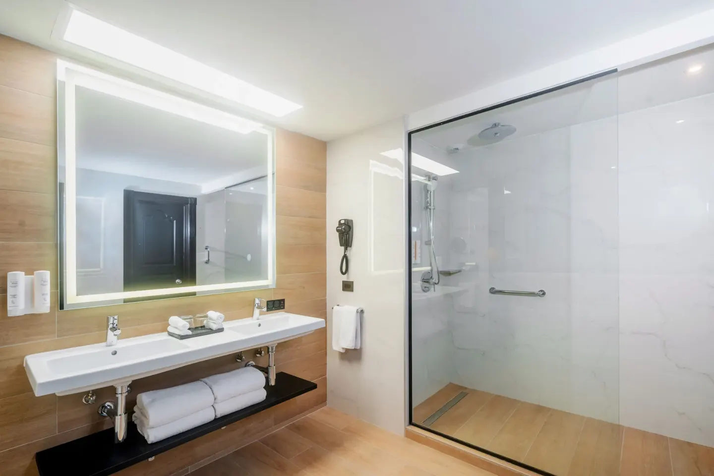 Bathroom of the Junior Suite 2 Bedrooms with double sink vanity and glass shower at Hotel Riu Palace Pacifico.