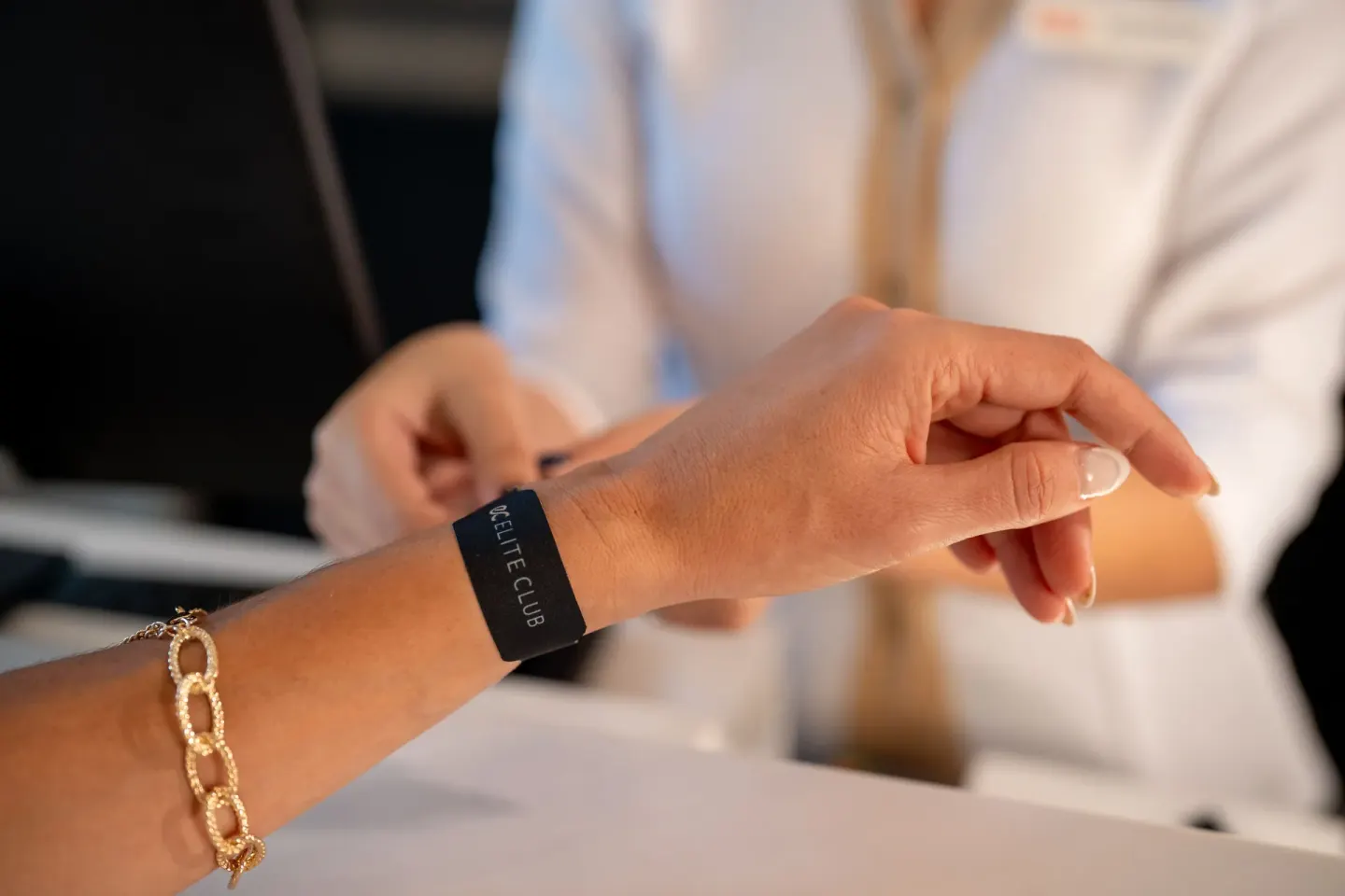 Elite Club wristband being fastened at Hotel Riu Palace Pacifico.