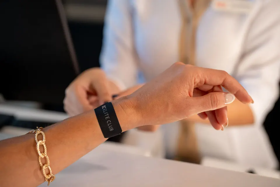 Elite Club wristband being fastened at Hotel Riu Palace Pacifico.