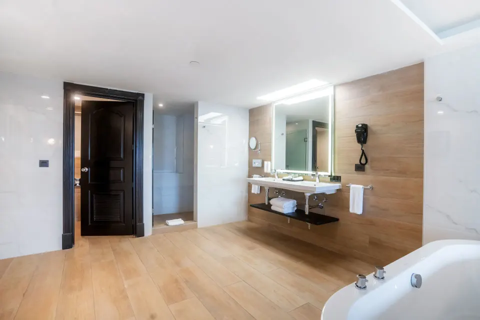 Spacious suite bathroom with vanity, tub, and shower at Hotel Riu Palace Pacifico.