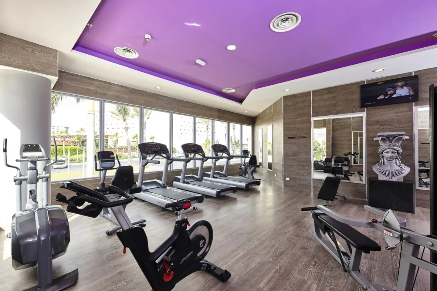 Bright gym with cardio machines and strength equipment at Hotel Riu Palace Paradise Island.