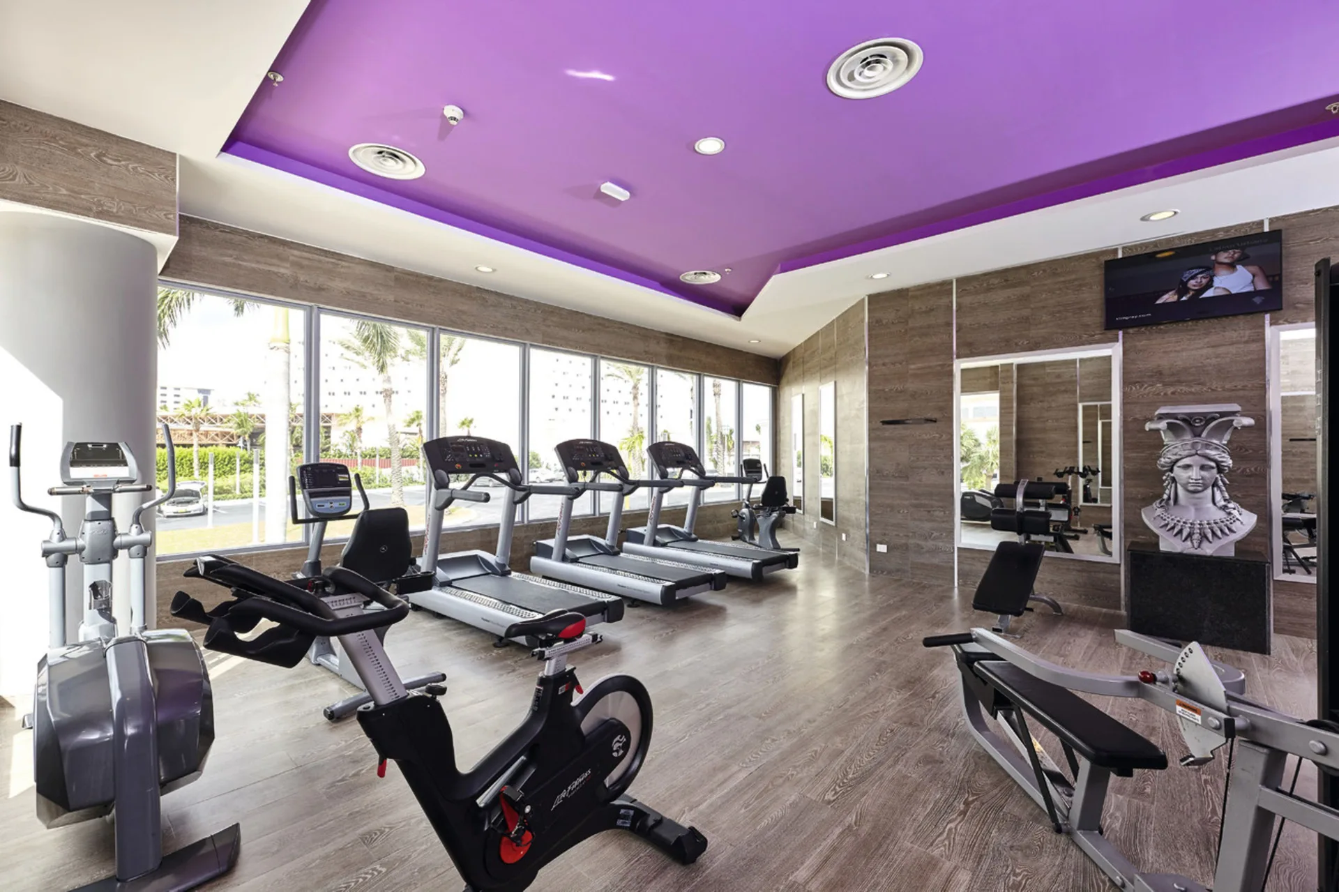 Bright gym with cardio machines and strength equipment at Hotel Riu Palace Paradise Island.