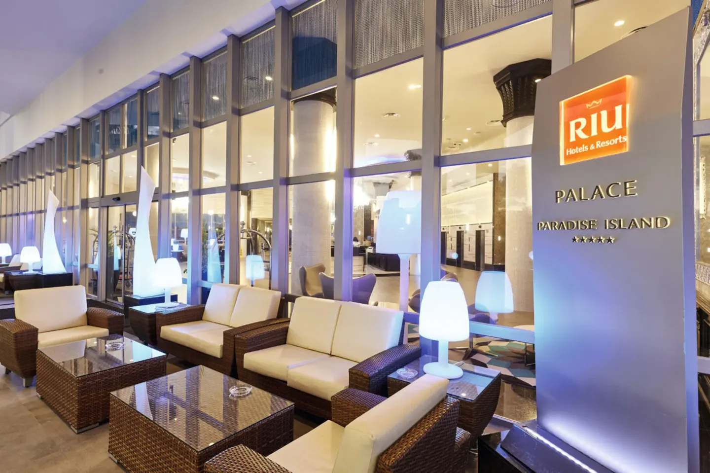 Entrance lounge seating and hotel sign at Hotel Riu Palace Paradise Island.