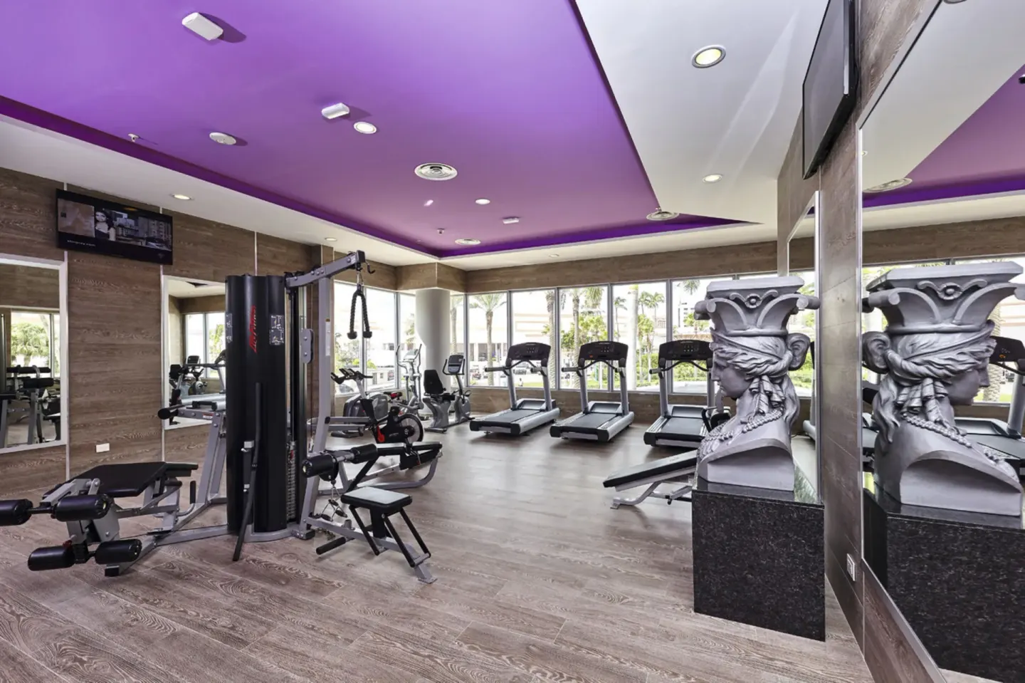Fitness room with treadmills and weight machines at Hotel Riu Palace Paradise Island.